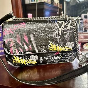DKNY crossbody purse. Black with graffiti on front